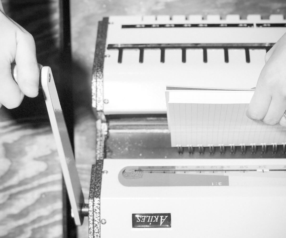 Girl using binding machine