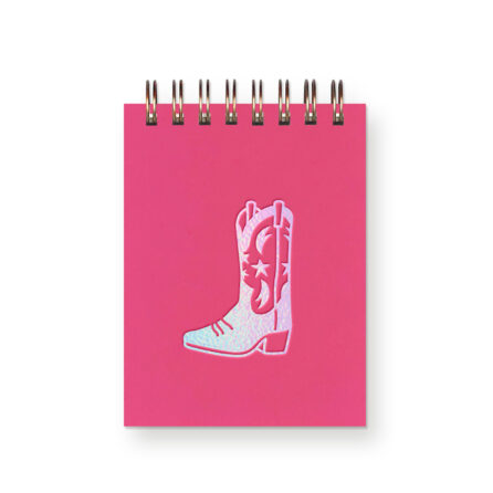 An iridescent foil cowboy boot on a hot pink miniature notebook
