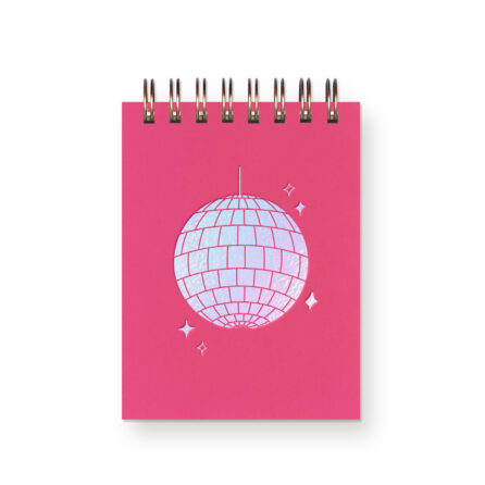 A hot pink miniature notebook with an iridescent foil disco ball on it