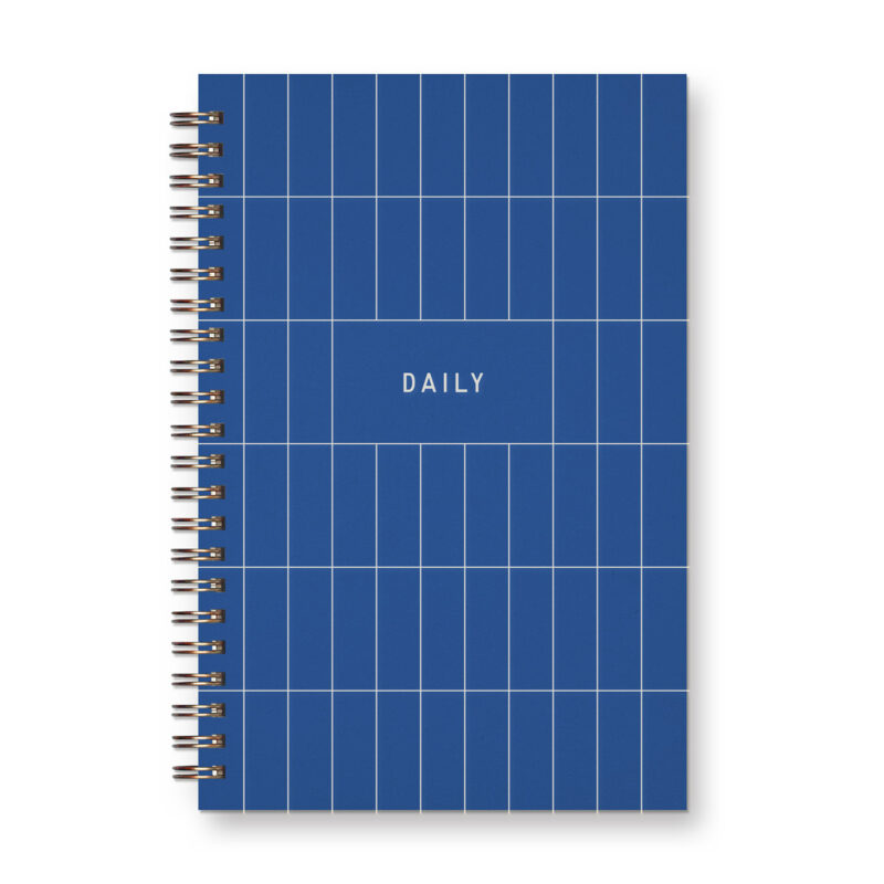A sapphire blue spiral bound notebook with white rectangular grid lines says the word "daily"